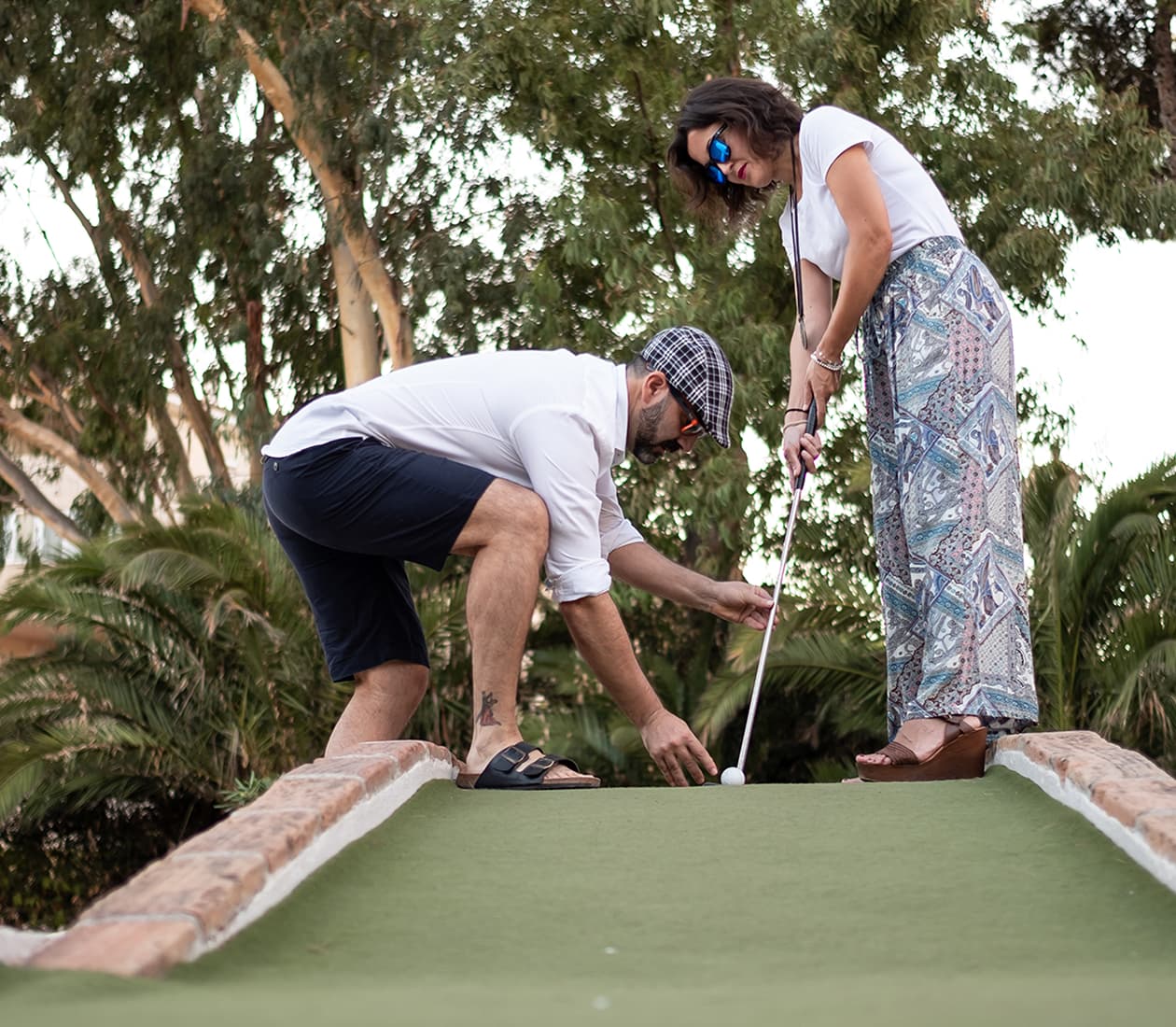 Family playing mini golf