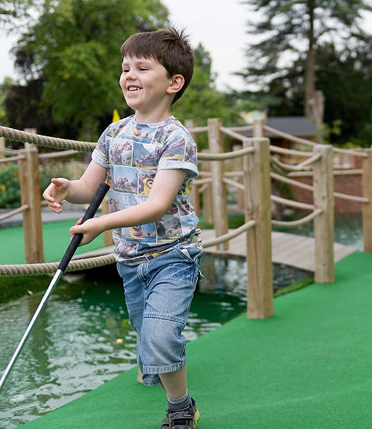 Child playing mini golf